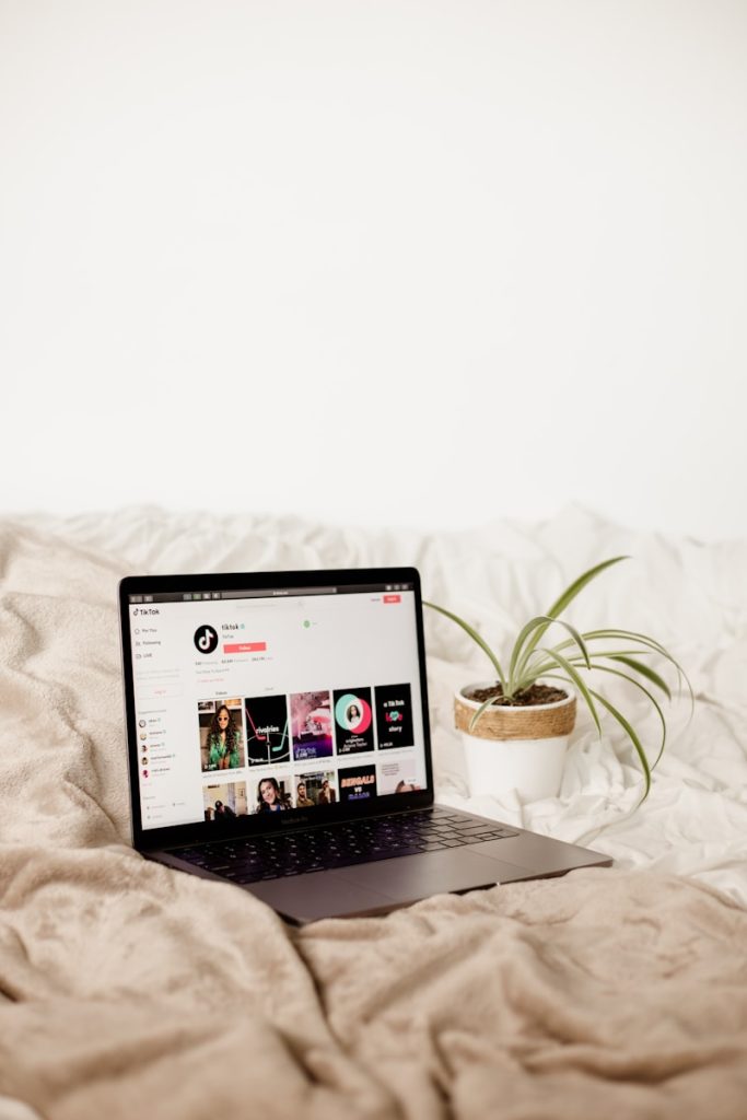 a laptop computer sitting on top of a bed